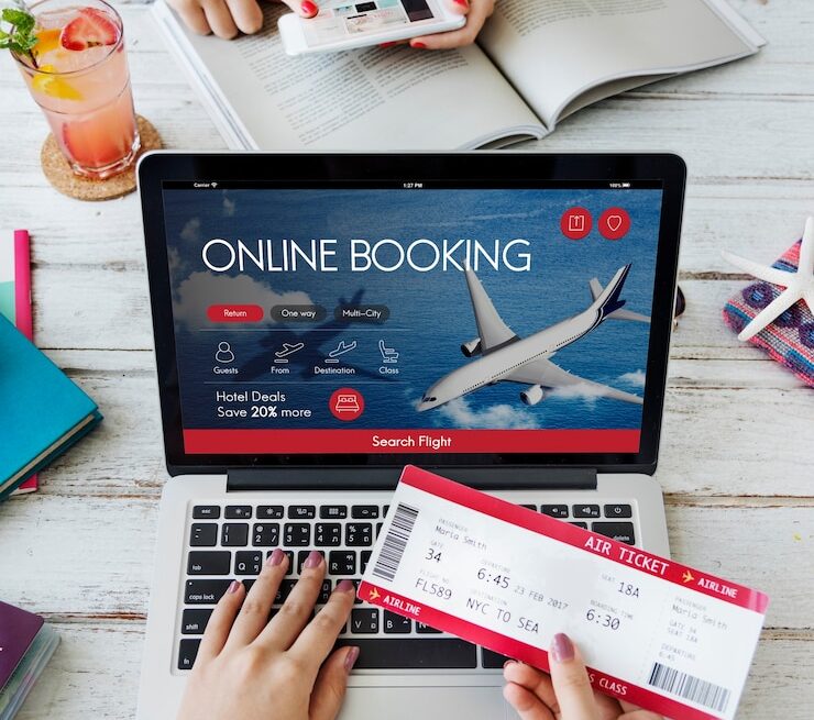 a person holding a ticket and a laptop