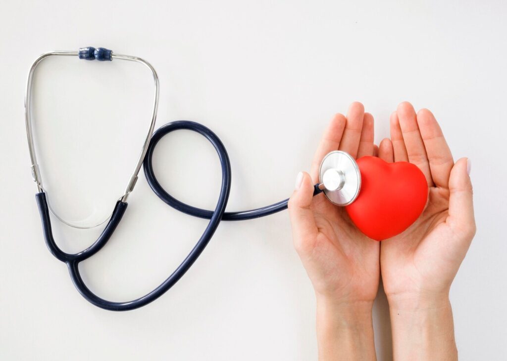 flat lay hands holding heart shape with stethoscope 23 2148635205